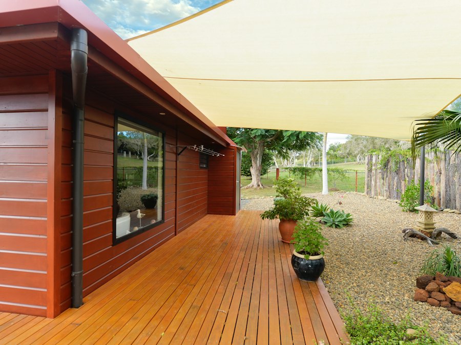 Stained timber deck running alongside a house