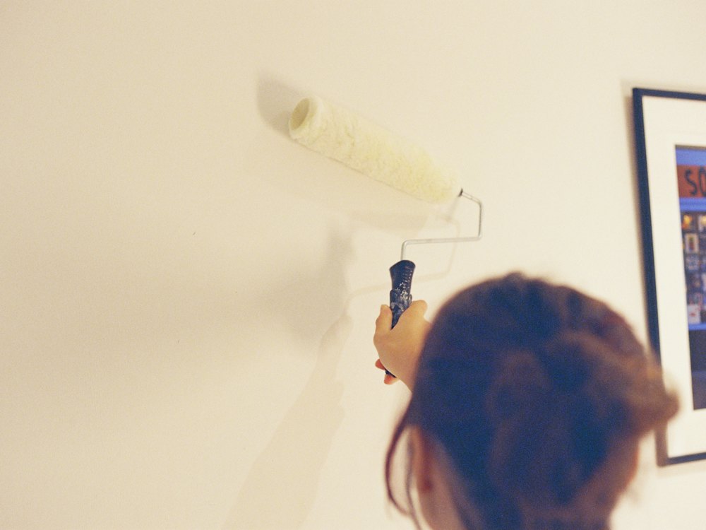 Painter rolling a fresh coat onto an interior wall